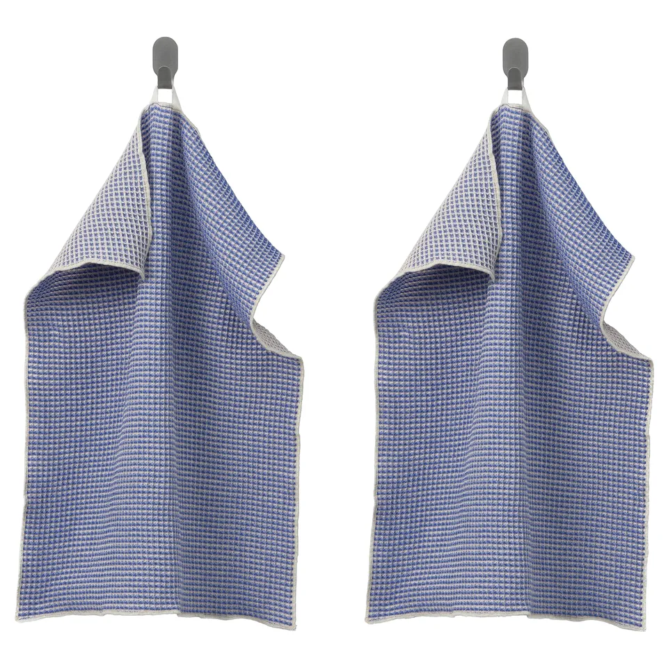 Two blue chequered towels hang from metal hooks.
