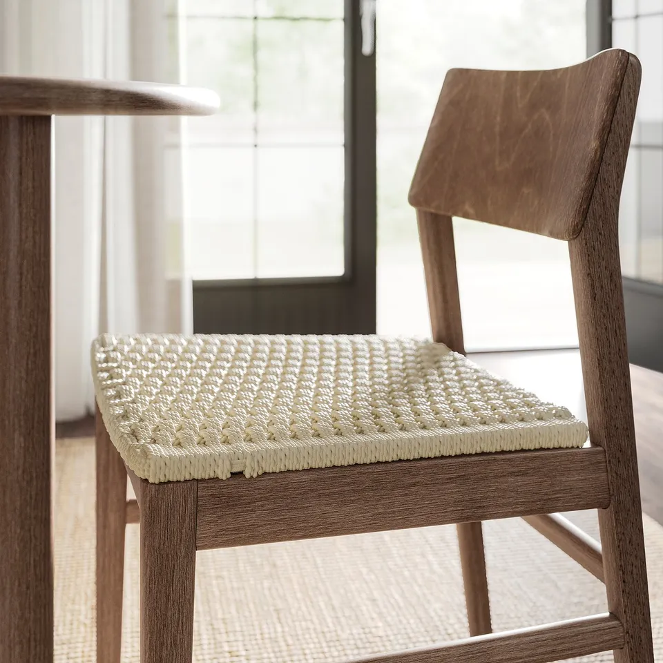 Chair with woven seat, light wood finish; well-crafted, sturdy design.
