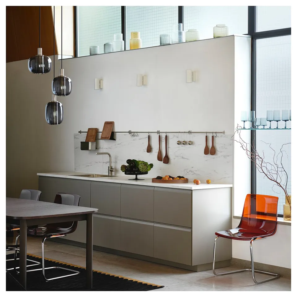 Modern kitchen with KUNGSFORS stainless steel rail, hanging utensils, and minimalist design.