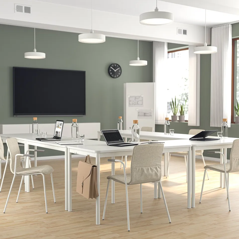 Modern conference room with LÄKTARE chairs, laptops, and tv.