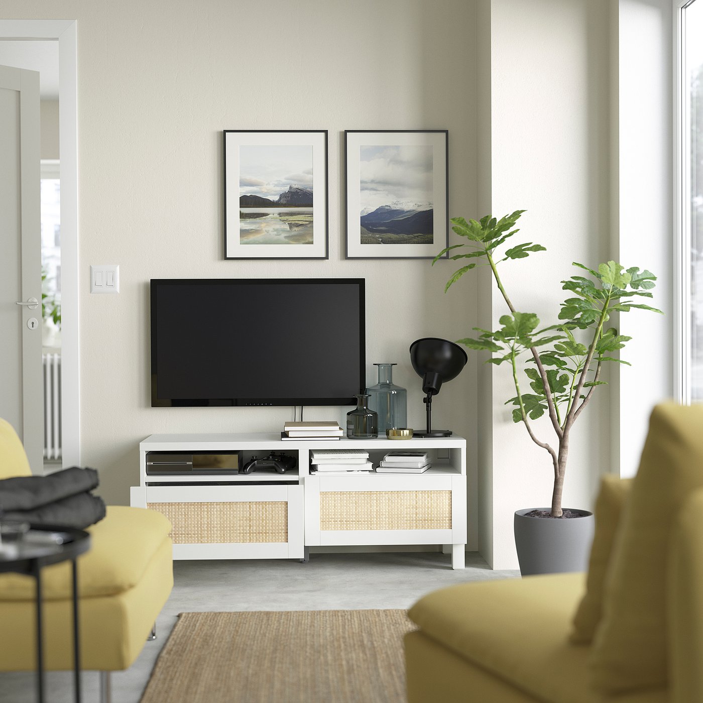 Modern living room with tv stand, cable management, storage, and a mounted flat screen plus decor and plant.