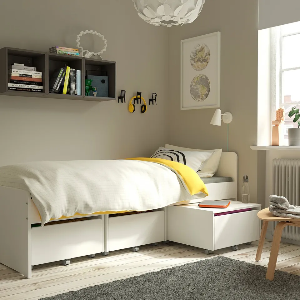 Modern bedroom with grey rug, white bed, yellow accents, wooden floors, and stylish furniture creating a cosy, inviting atmosphere.