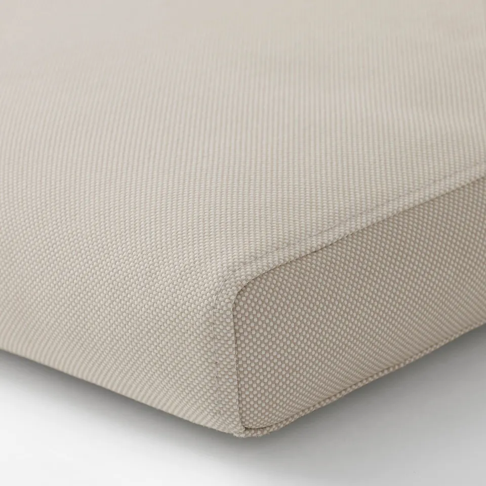Close-up of soft, textured beige cushion.