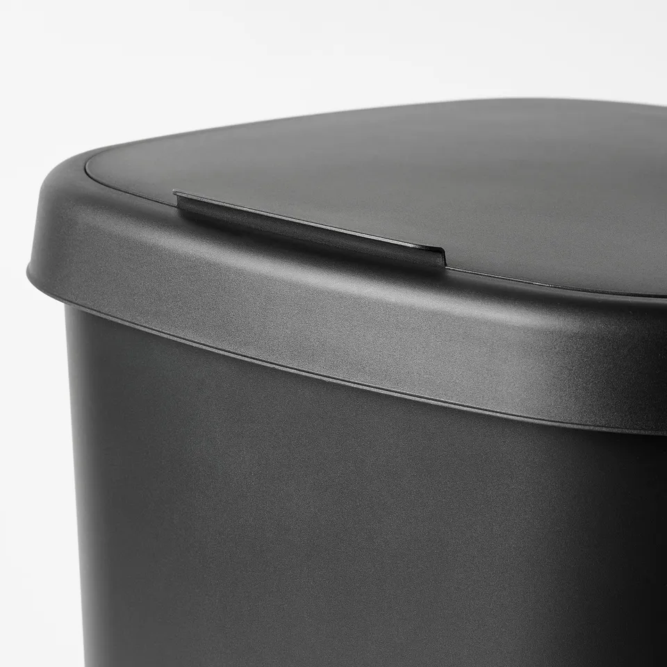 Black plastic bin with lid, designed for waste sorting, featuring secure bag handling.