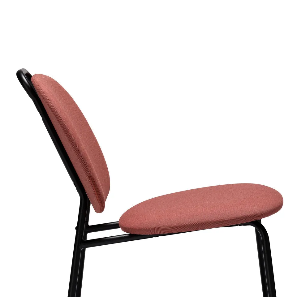 Pink fabric chair with black metal legs, showing high-quality upholstery and sturdy frame, ideal for comfort.