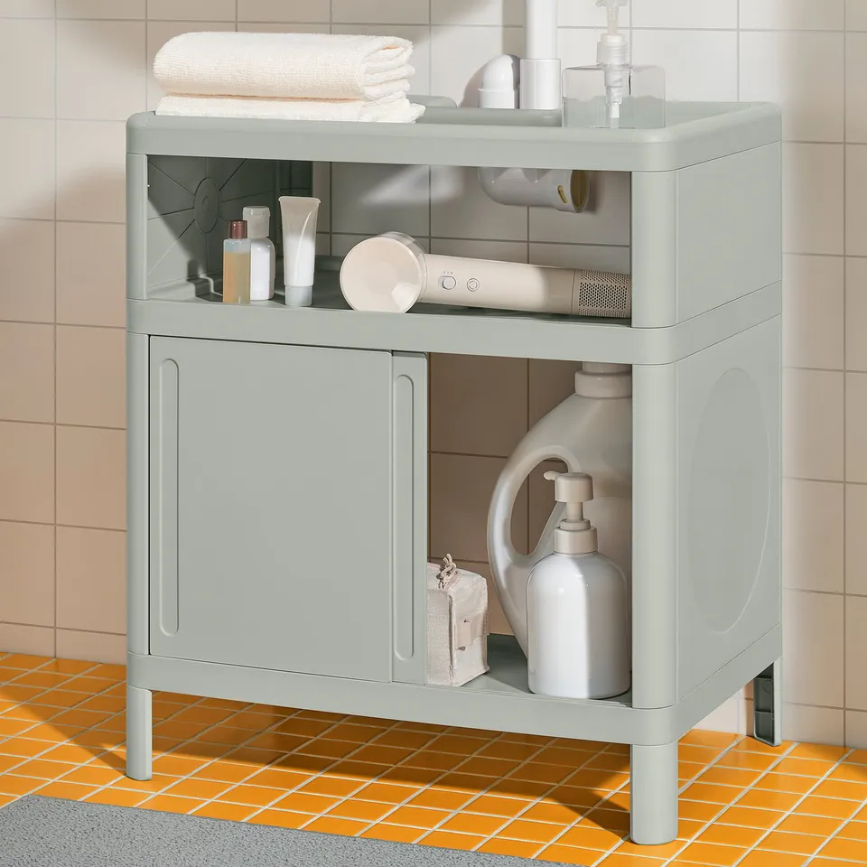 Modern bathroom cabinet in mint, storing towels, toiletries, hair dryer, soap dispenser, and cleaning supplies efficiently.