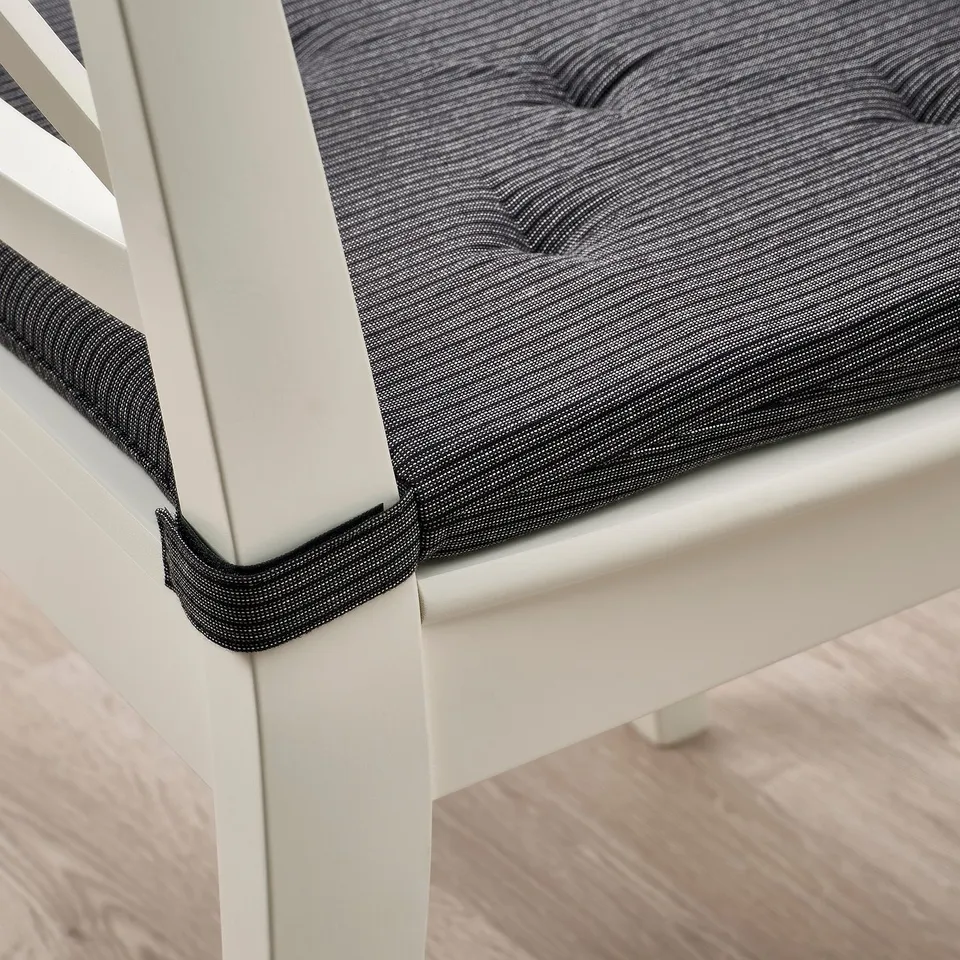 Chair cushion with elastic corners for secure fit, providing comfort with thick foam.