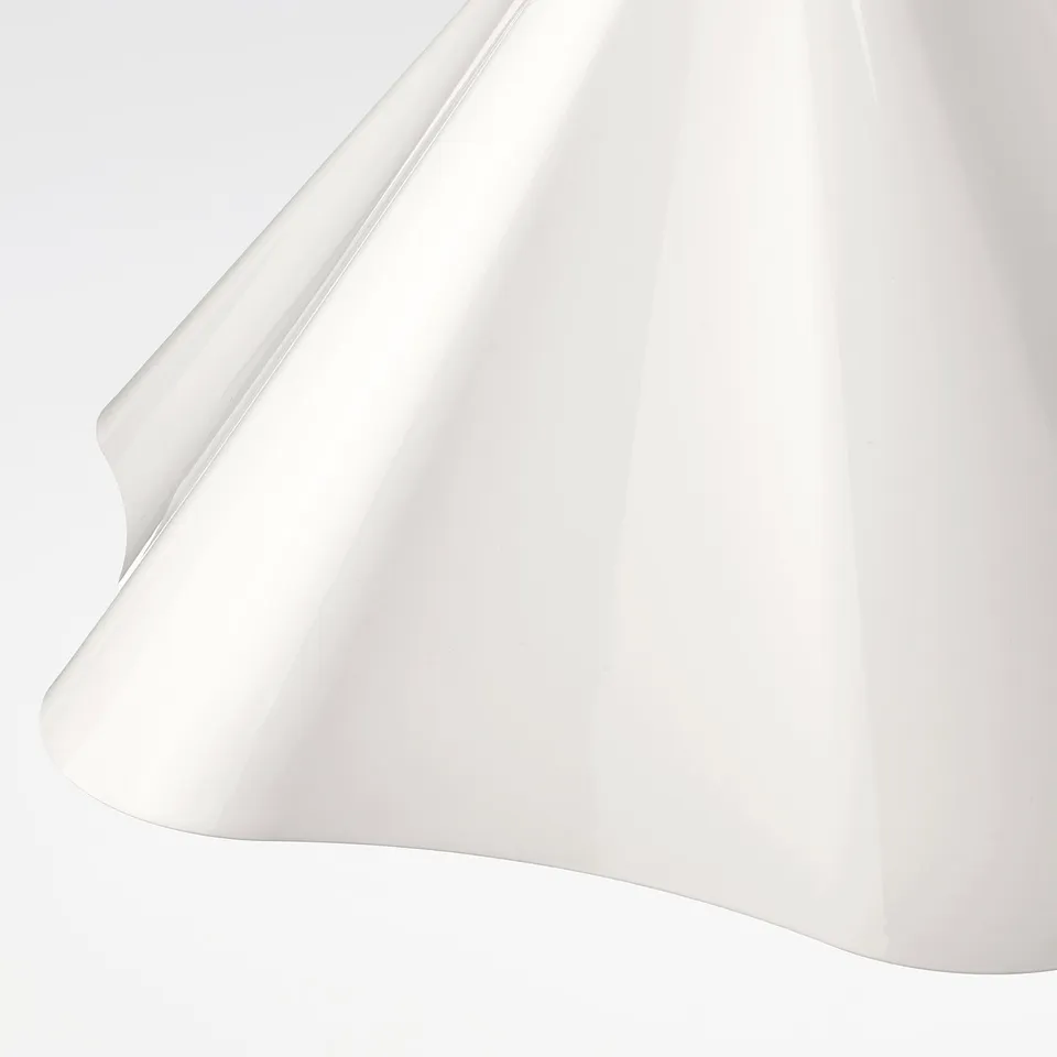 Pendant lamp with sleek, asymmetric shape; smooth, luminous surface; modern and inviting design.