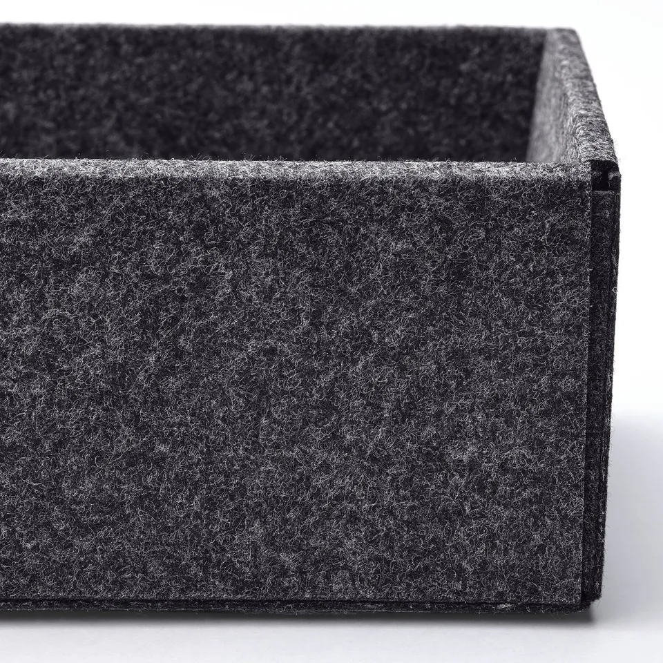 Close-up of soft, dark grey drawer organiser. Tidy, plush, sound-dampening.