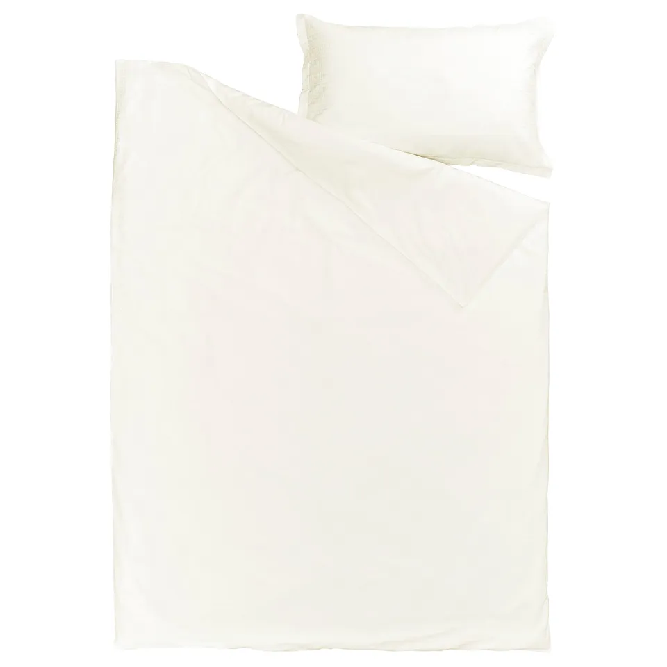 A white LUKTVICKER duvet cover set in waffle weave, made from 100% soft cotton.