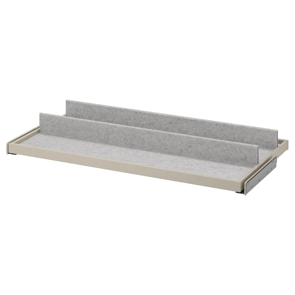 A KOMPLEMENT grey pull-out tray shelf with felt lining, perfect for organising items.