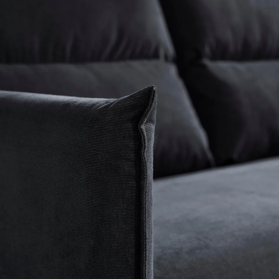 Dark grey sofa with plush, inviting cushions and a sleek, modern design, focusing on comfort and elegance.