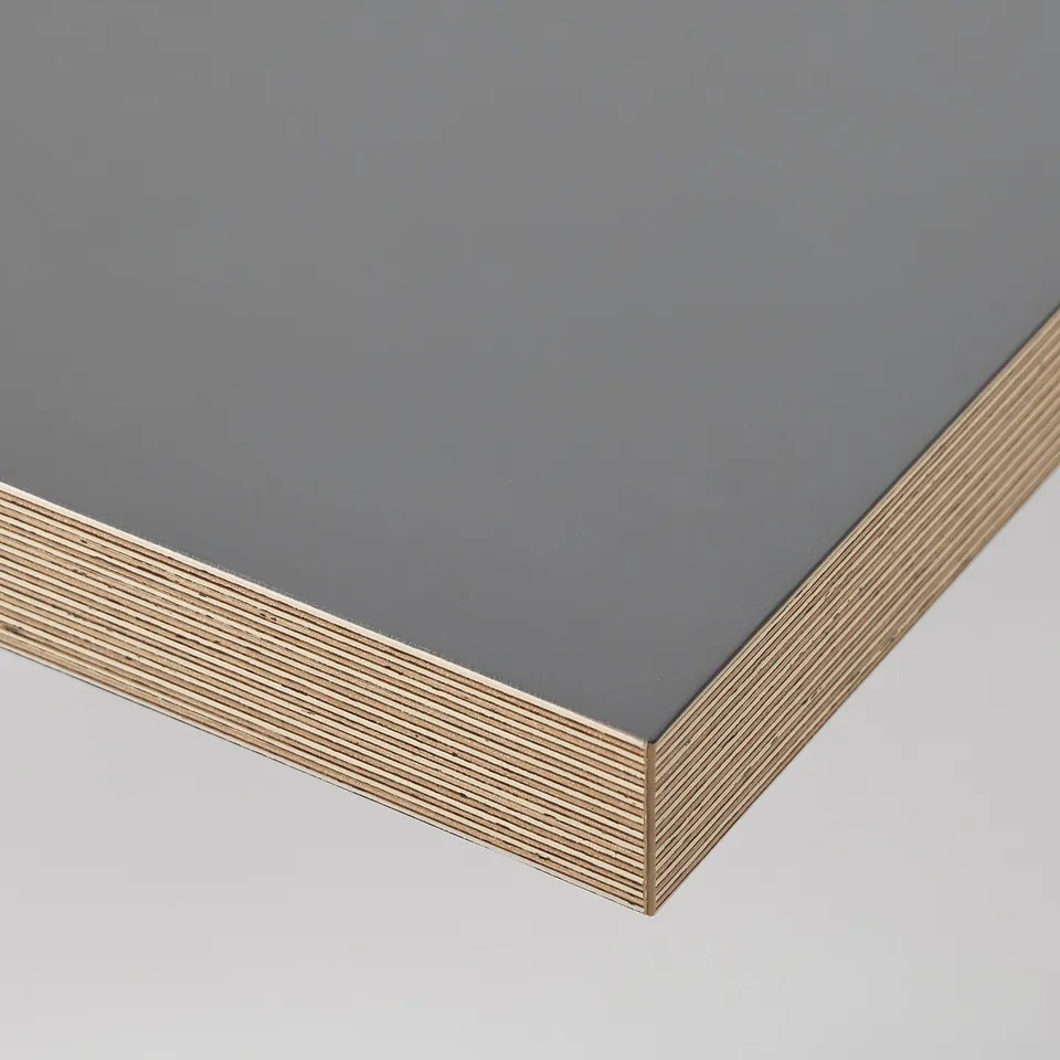 Dead-on view of sleek, dark desk top with stylish wood grain edge band, showcasing quality craftsmanship.