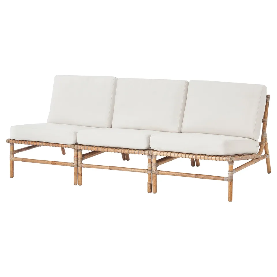 White outdoor sofa with woven rattan frame and cushions.