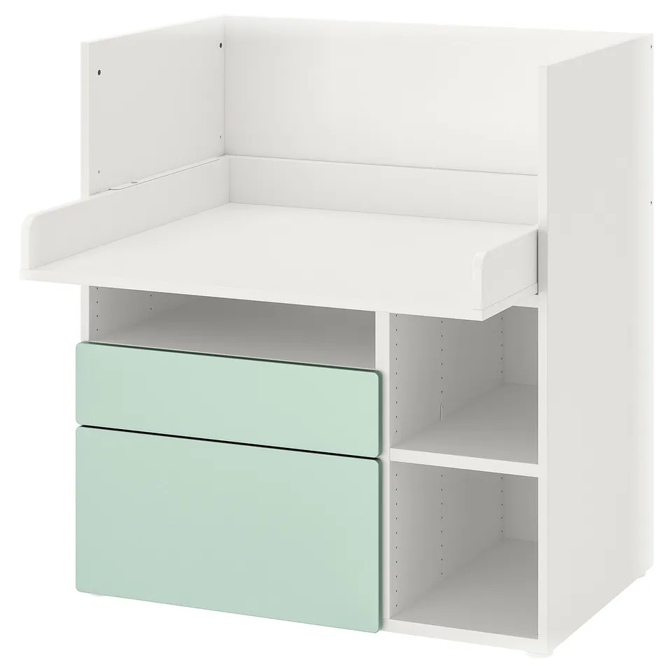White and light green kids changing table/desk with drawers and shelves.