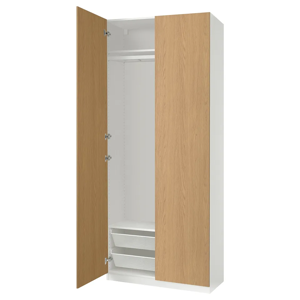 Open wooden wardrobe with white interior. Narrow frame, soft-closing hinges, mesh shelves.