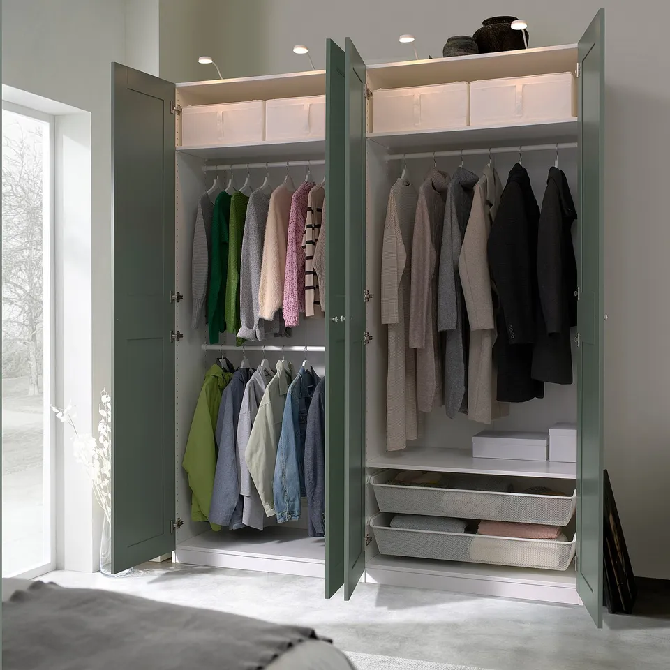 Open wardrobe with sorted clothes, boxes, and storage baskets; built-in lighting, adjustable shelves.