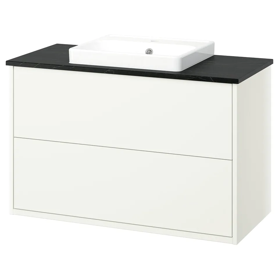 Modern white bathroom vanity with black marble countertop and vessel sink.