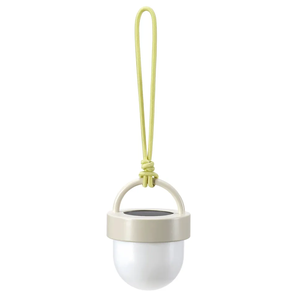 The SOLVINDEN solar-powered light is white, spherical, with a beige handle and a lime-green rope. Its modern and eco-friendly.