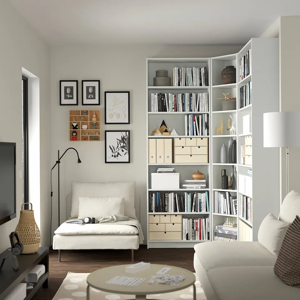 Modern living room with BILLY bookcases, couch, and lamp.