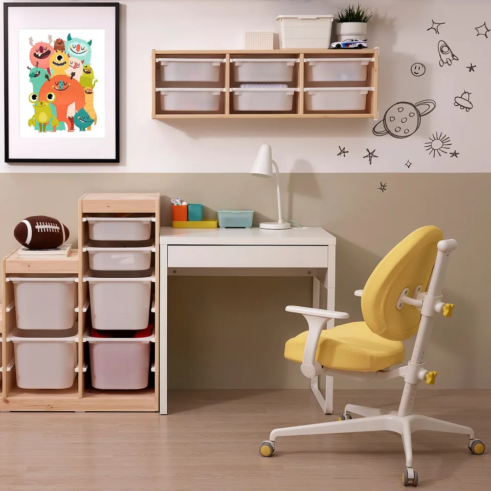 Study area with MICKE desk, yellow office chair, shelves, and football.