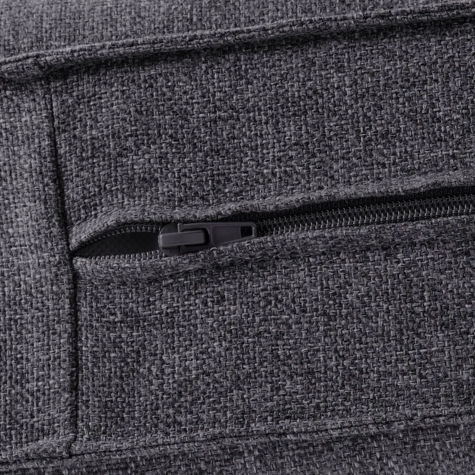 Close-up of high-quality, textured fabric pocket on a cosy sofa, showcasing sturdy zip detail.