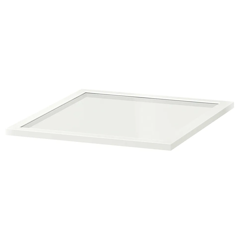 A KOMPLEMENT glass shelf, white, rectangular, with a clear glass panel framed by white fibreboard.