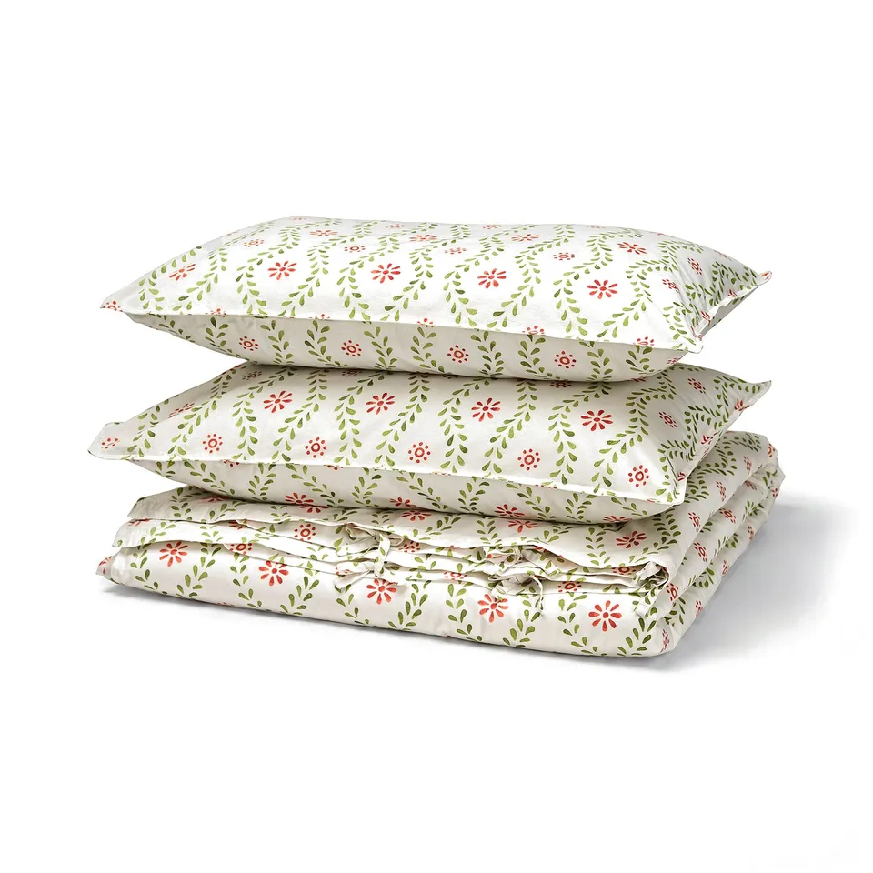 FYRISVIDE duvet set, white with red/green floral print, rectangular, soft cotton, neatly stacked.