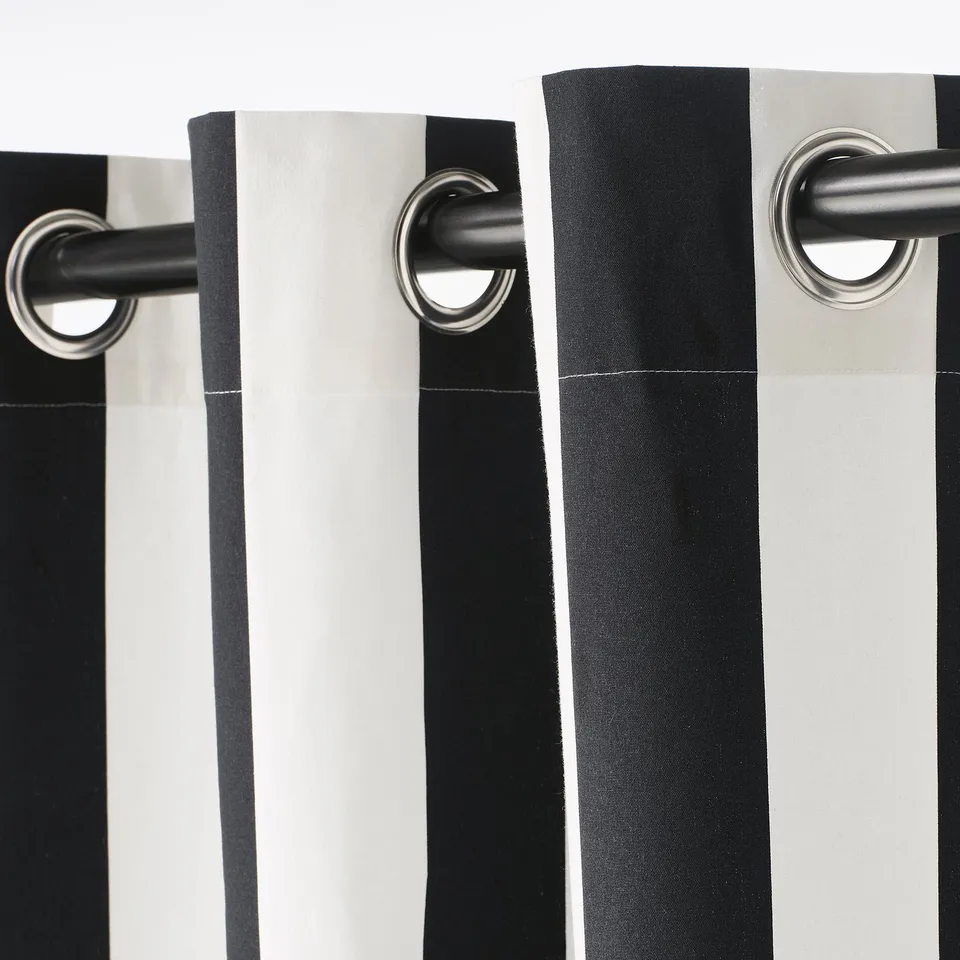 Black and white striped curtains with silver eyelets for modern, easy-glide window dressing.