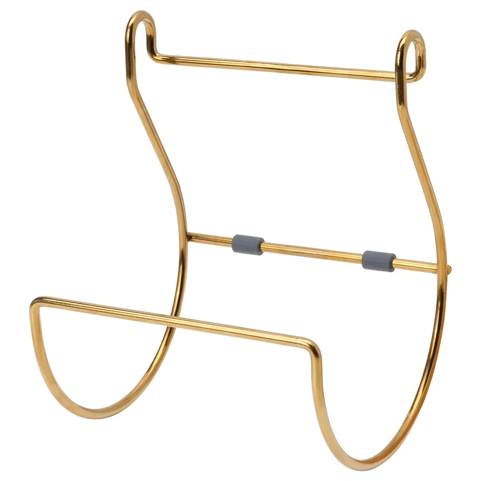 A gold HULTARP wall-mounted organiser with a curved, elegant design. It hooks and bars for hanging items, made of nickel-plated steel.