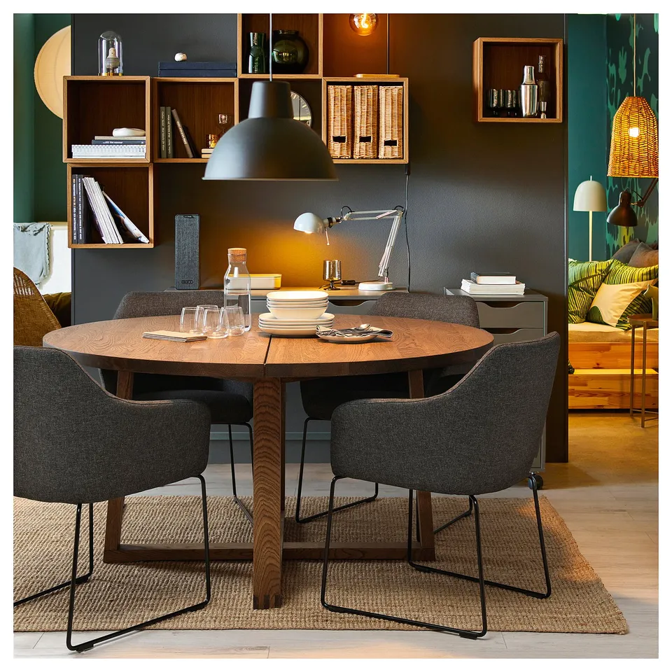 Four TOSSBERG charcoal chairs around wooden table, bright dining room with bookshelf.