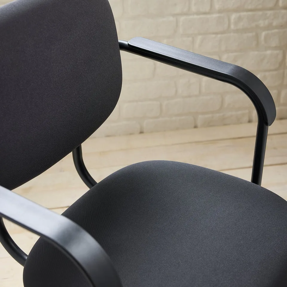 Modern black chair with sleek metal armrests, upholstered in smooth fabric. Sit comfortably and stylishly.
