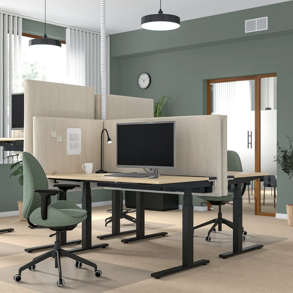 Office with MITTZON beige acoustic screens, green chairs, and black pendant lights.