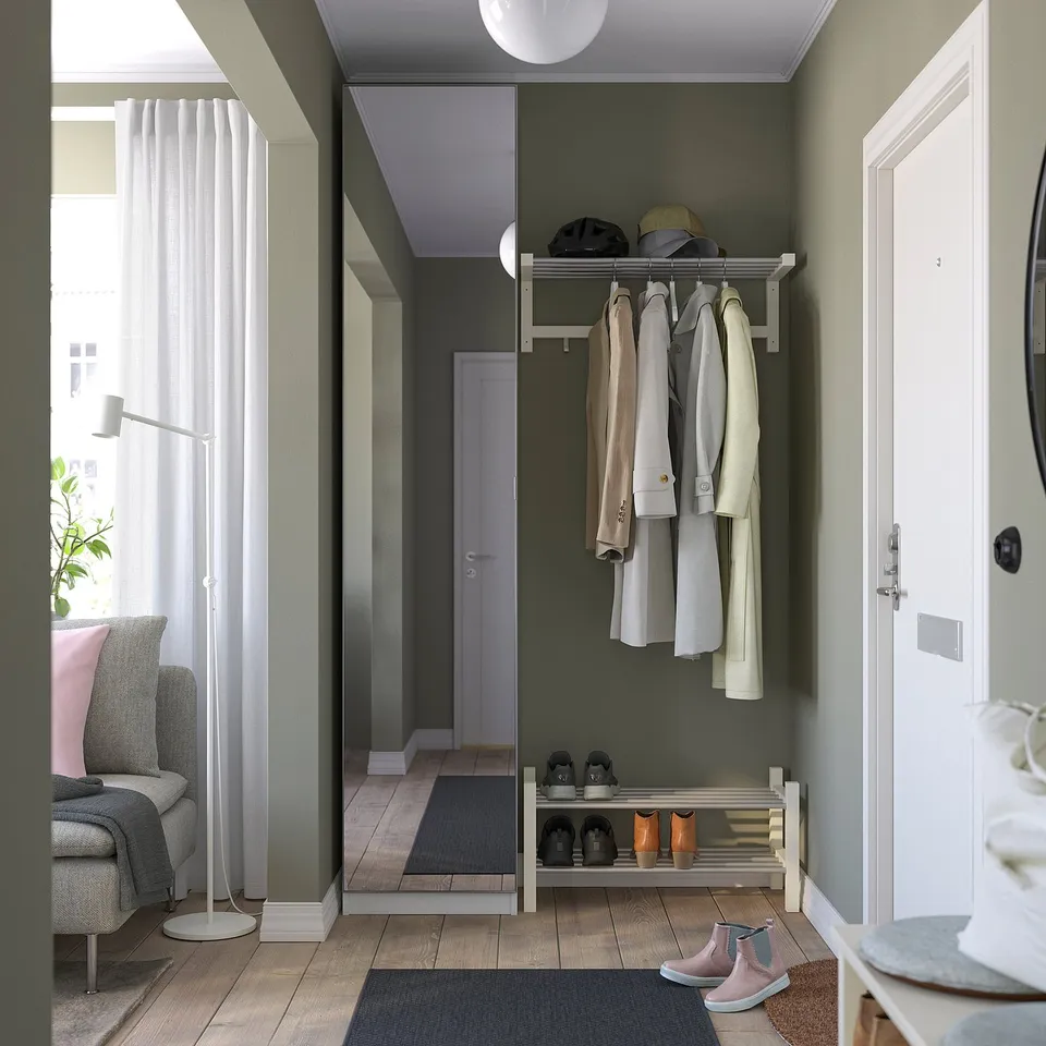 Modern entryway: shoe & coat rack, chair, lamp, window.