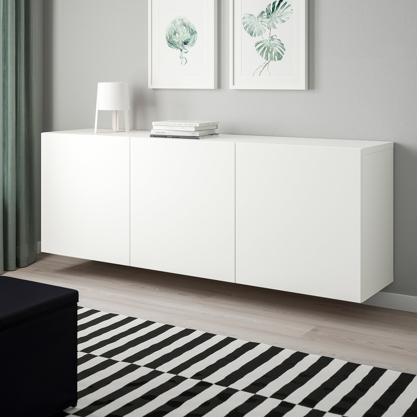 Modern room with BESTÅ storage, books, lamp & art, minimalist.