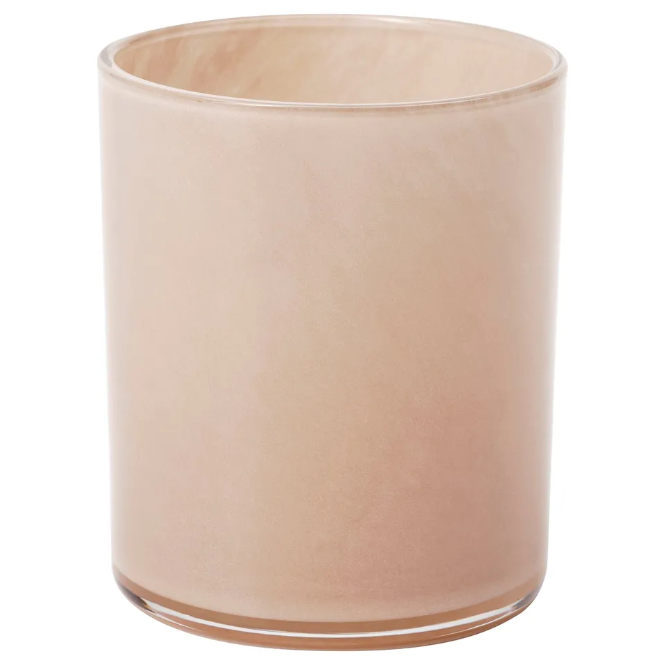 Peach-colored, cylindrical glass candle holder.
