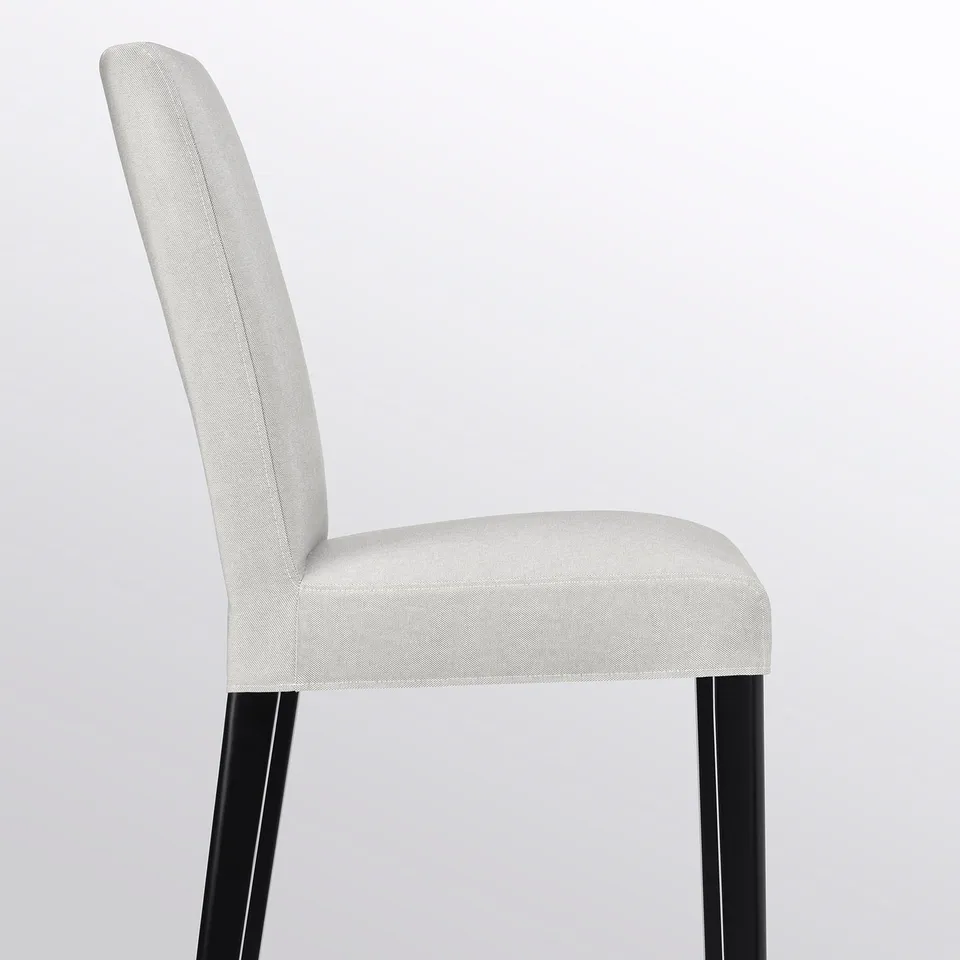 Elegant BERGMUND chair, high back, sleek white upholstery, black wooden legs, promising comfort and durability.