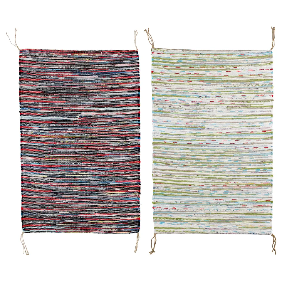 Two colourful, rectangular, handwoven TÅNUM cotton rugs, one primarily dark, the other light.