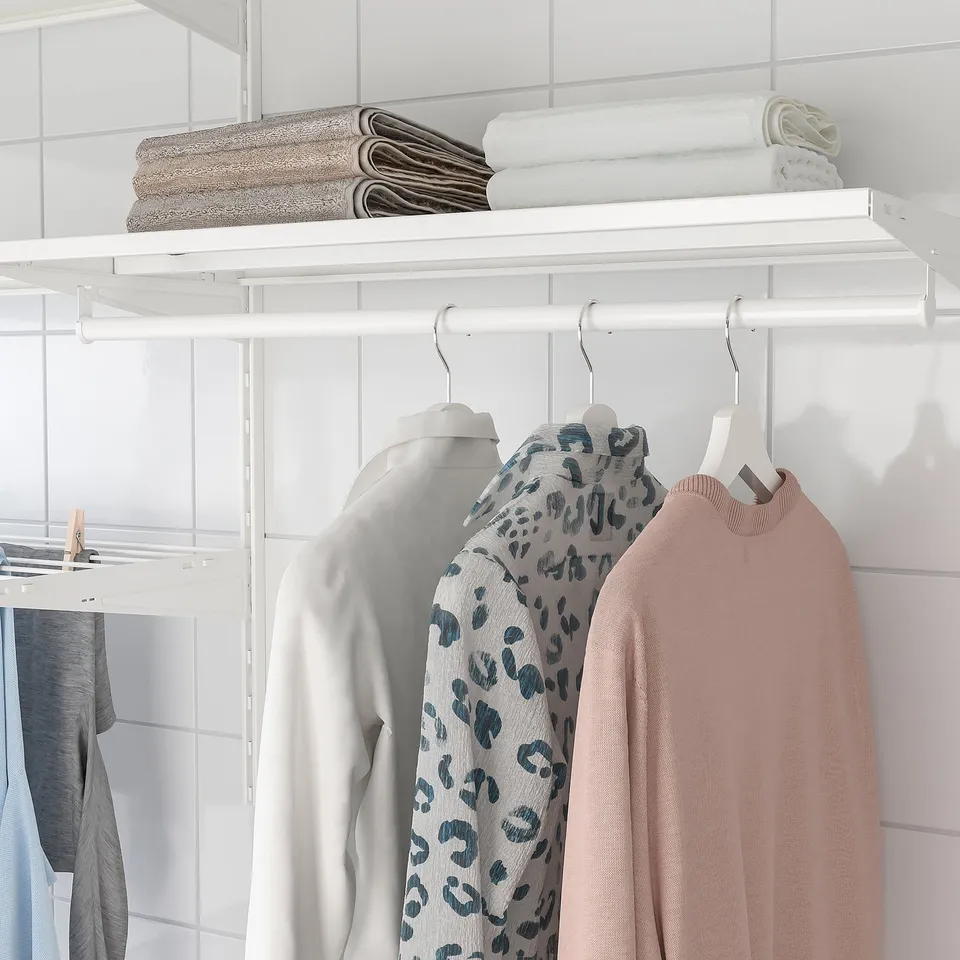 Closet shelf with sweaters and folded towels; part of BOAXEL storage system.