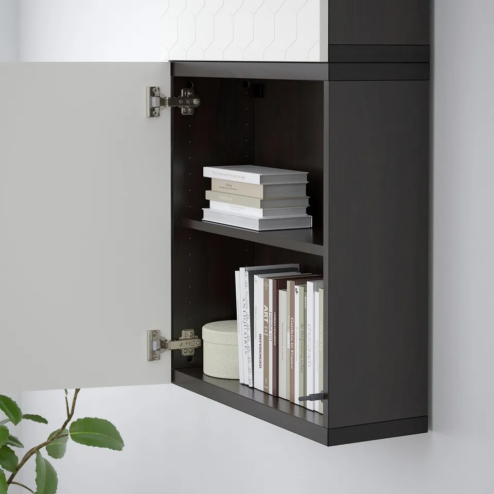 Black wall-mounted bookshelf with two shelves holding books.