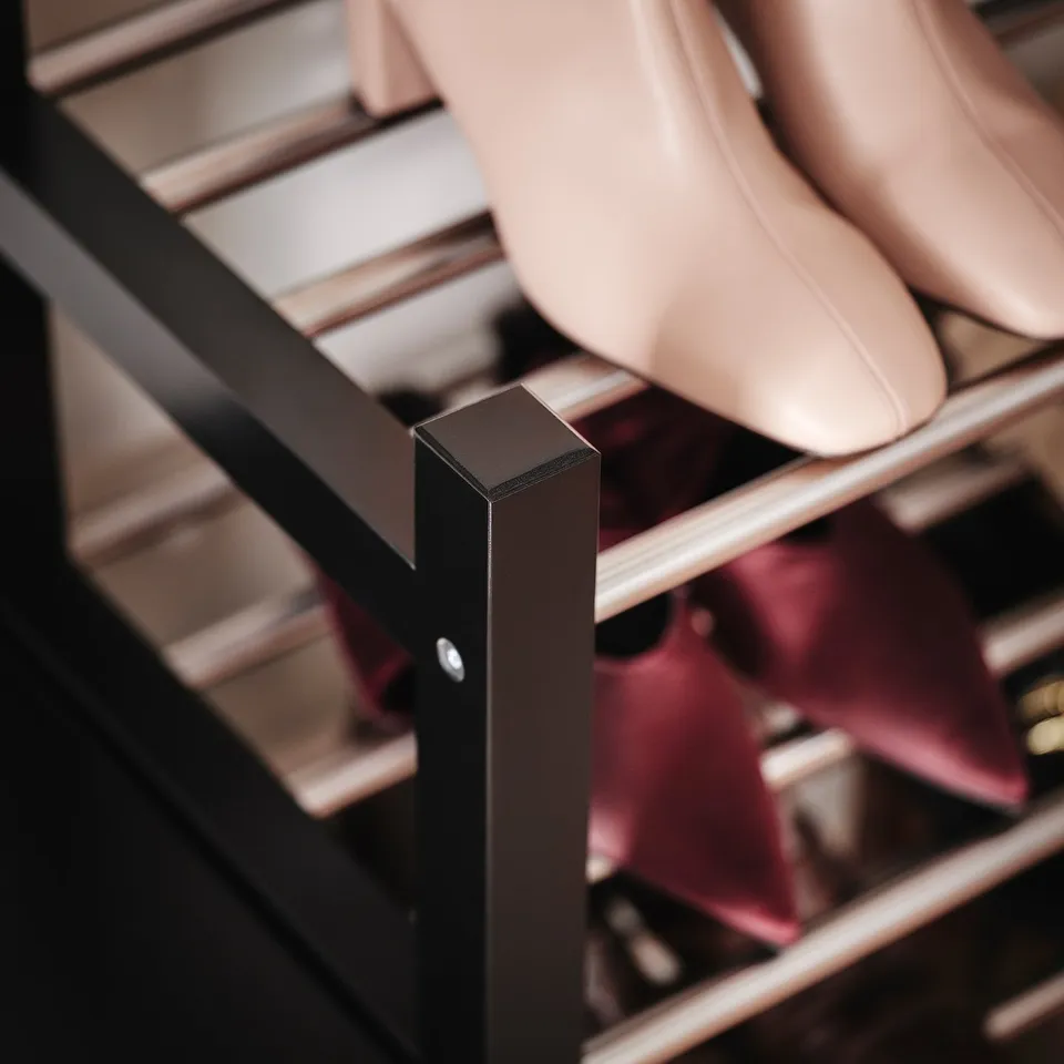 Shoe rack with sleek black metal frame, supporting organised storage. High-quality wood and steel construction, ensuring durability.