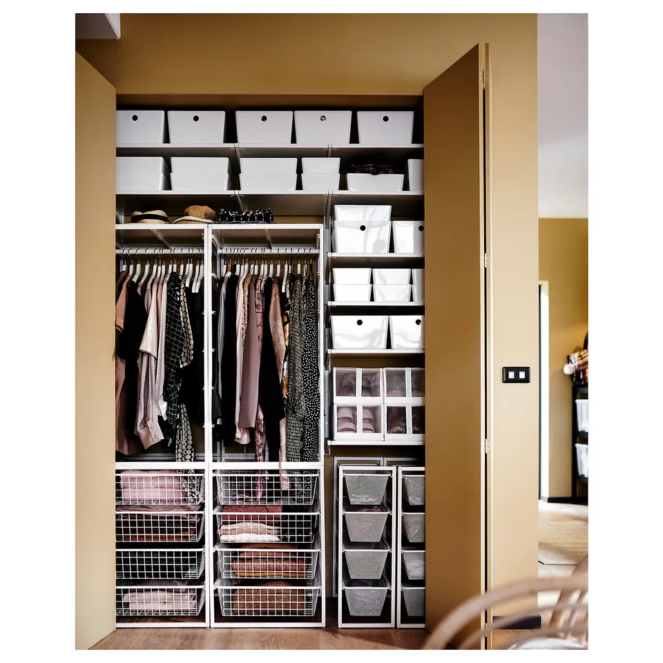Organised closet with JONAXEL storage. Clothes and folded items neatly arranged.