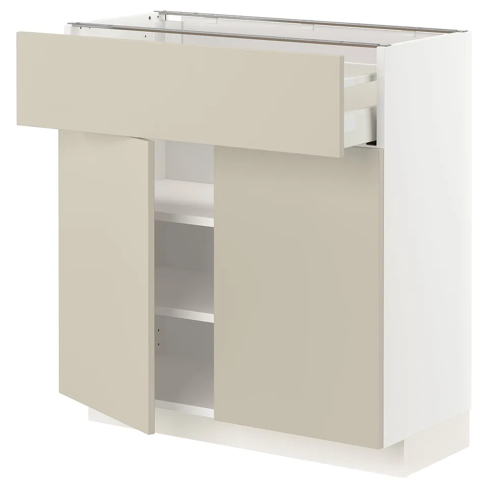 White and beige kitchen cabinet from IKEAs METOD series with adjustable shelves and smooth drawer fronts.