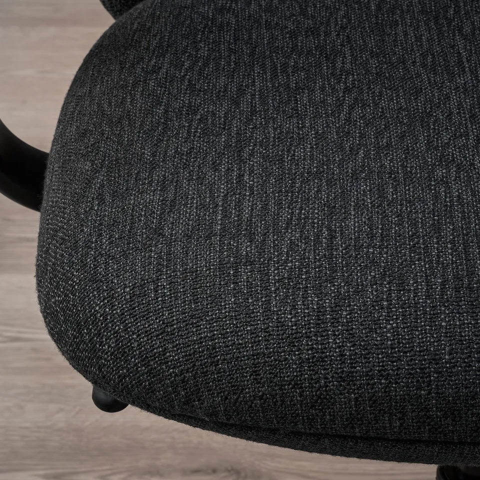 Close-up of a modern office chairs upholstery, showcasing high-quality, textured fabric on a stylish, ergonomic design.