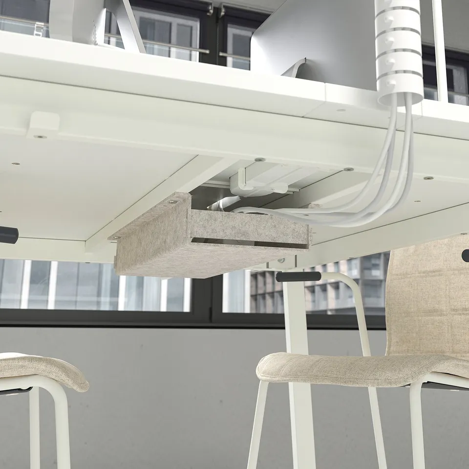 Understanding desk with attached leg rest, promoting comfort during long meetings.