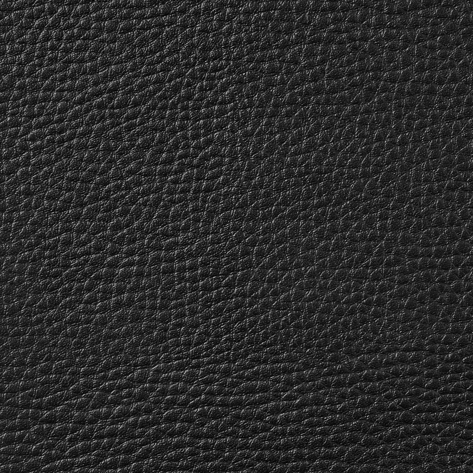 Close-up of textured black leather, showcasing smooth grain and subtle variations.