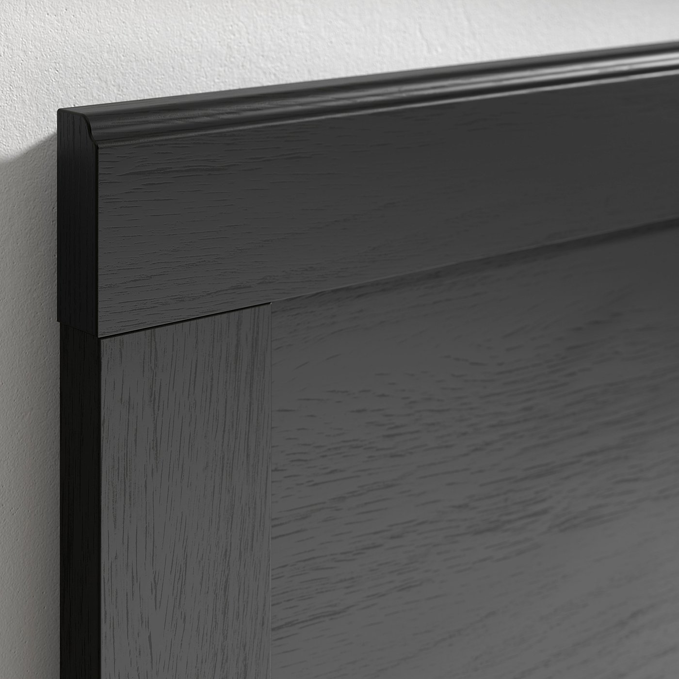 Dark wood bed frame corner, showing smooth finish & sturdy design.