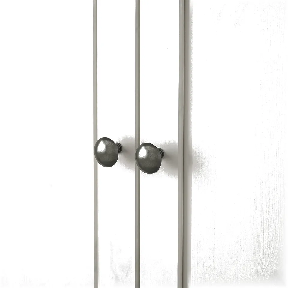 Knobs: smooth metal, round design, solidly attached. Wardrobe: white-painted, vertical panels. Finish: clean, durable, high quality.