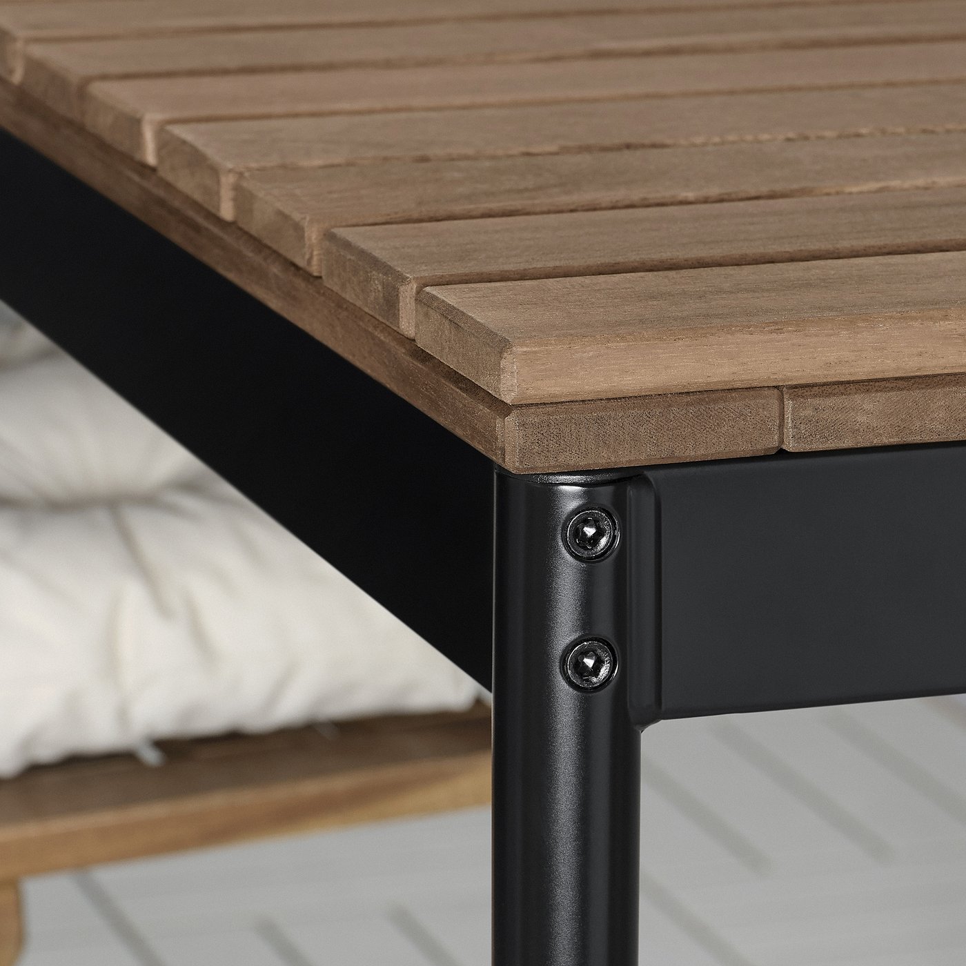 Table detail: sturdy acacia wood, sleek metal legs, precision screws.