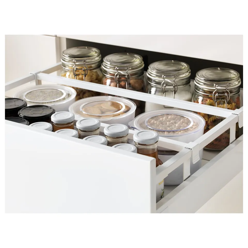 Open kitchen drawer displaying organisation: jars of food and containers, suggesting efficient storage and easy access.